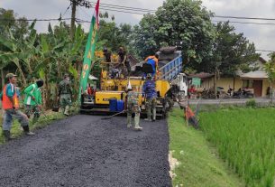 Manunggal, Satgas TMMD Bojonegoro Dan Warga Jatimulyo Ratakan Pasir Untuk Pengaspalan Jalan