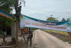 Dilokasi TMMD Kodim Bojonegoro Satgas Bentangkan Sepanduk