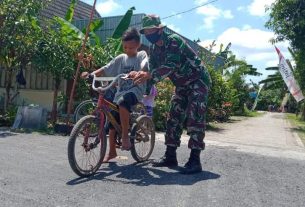 Jalan Aspal TMMD Bojonegoro Mulus, Satgas Ajari Anak Ngrancang Bersepeda