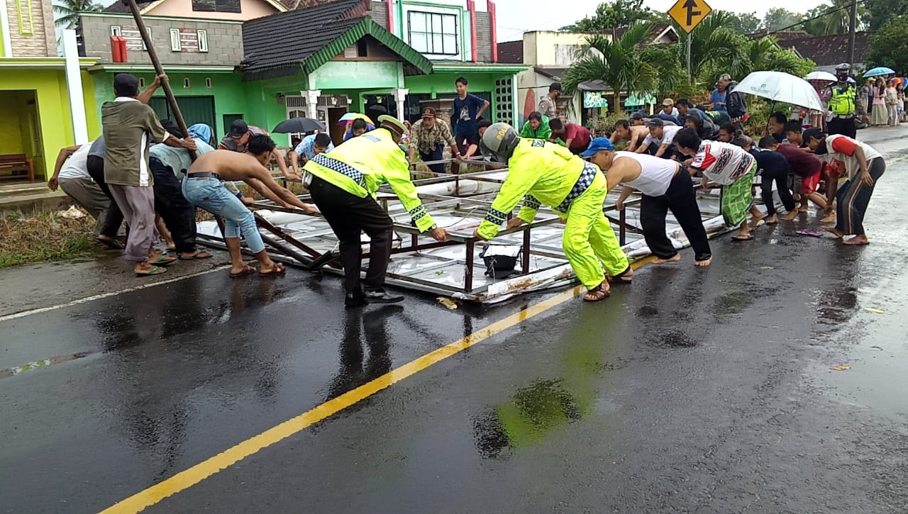 Petugas Gabungan Dibantu Warga Evakuasi Baliho Tumbang di Jalinbar Pugung