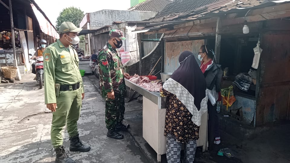 Cegah Penyebaran Covid-19, Serda Mujono Bersama Linmas Berikan Himbauan Prokes di Pasar Tradisional